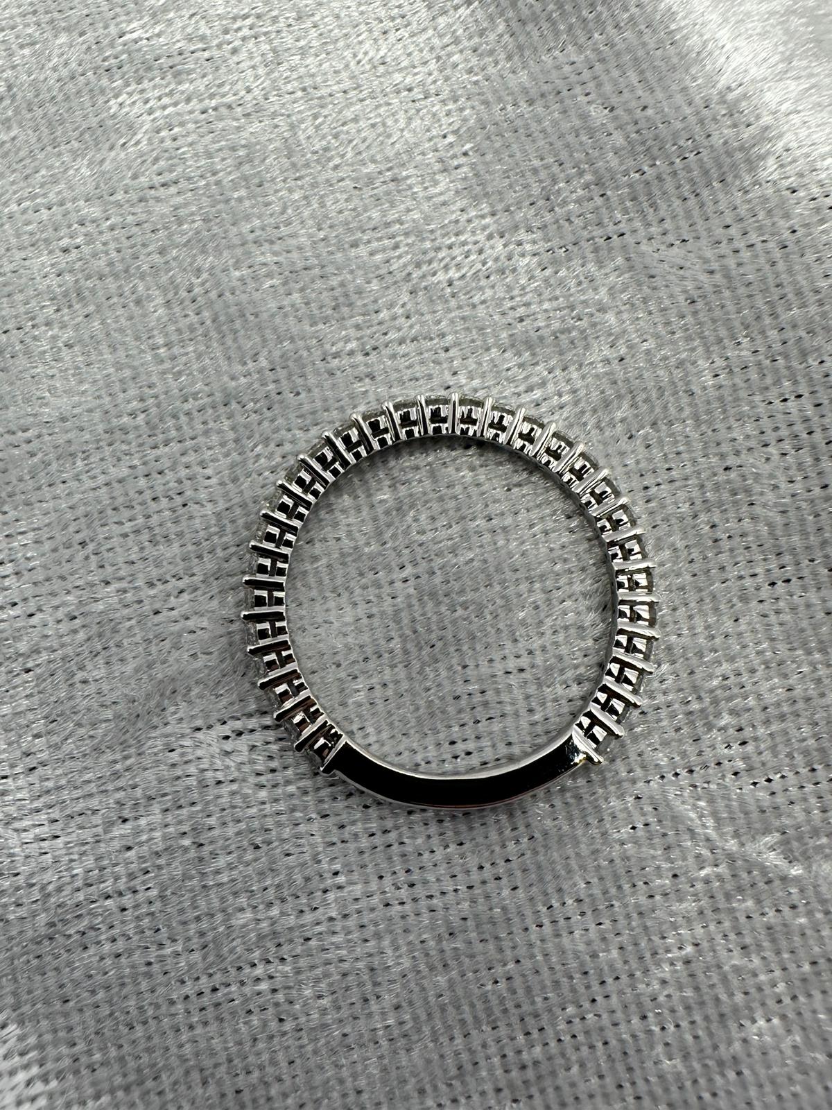 Stunning 18K white gold shared claw diamond band ring.
