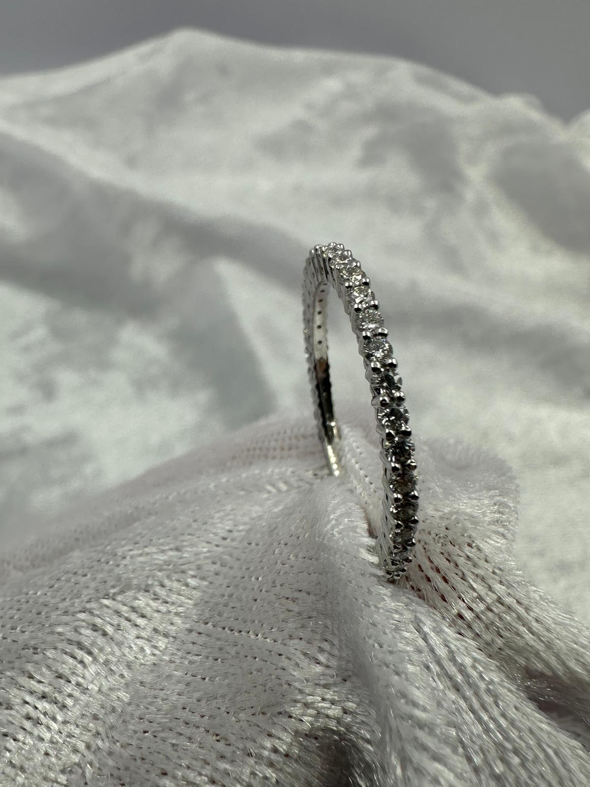 Stunning 18K white gold shared claw diamond band ring.