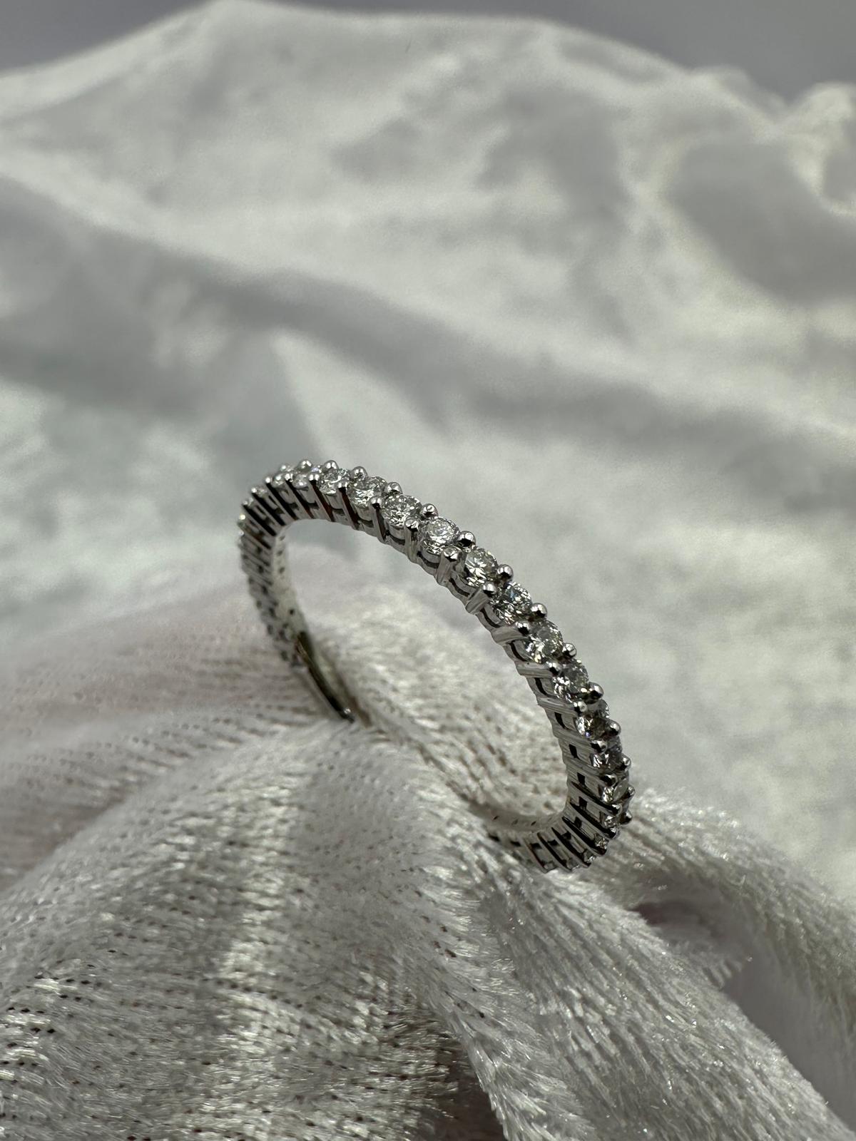Stunning 18K white gold shared claw diamond band ring.