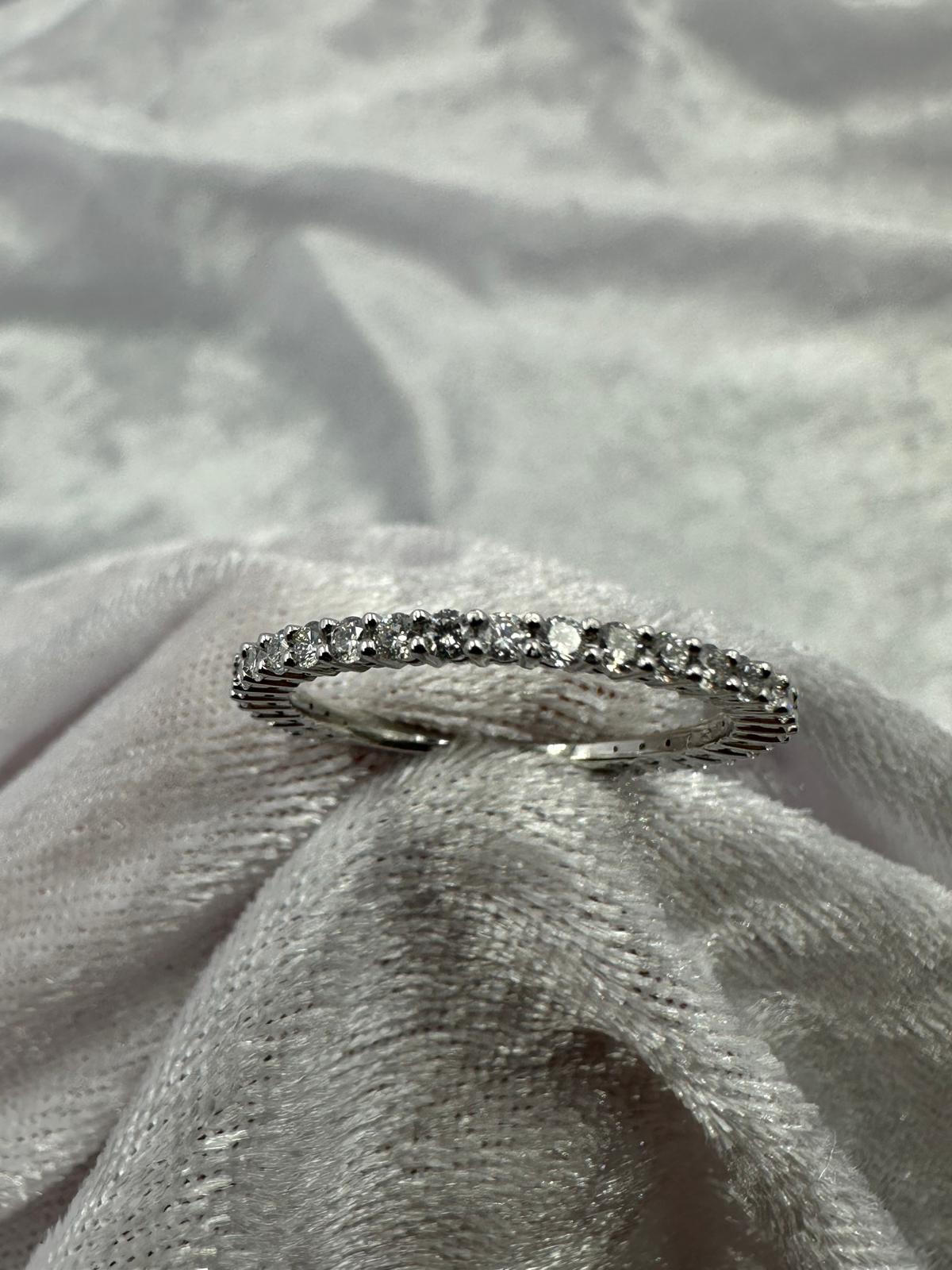 Stunning 18K white gold shared claw diamond band ring.