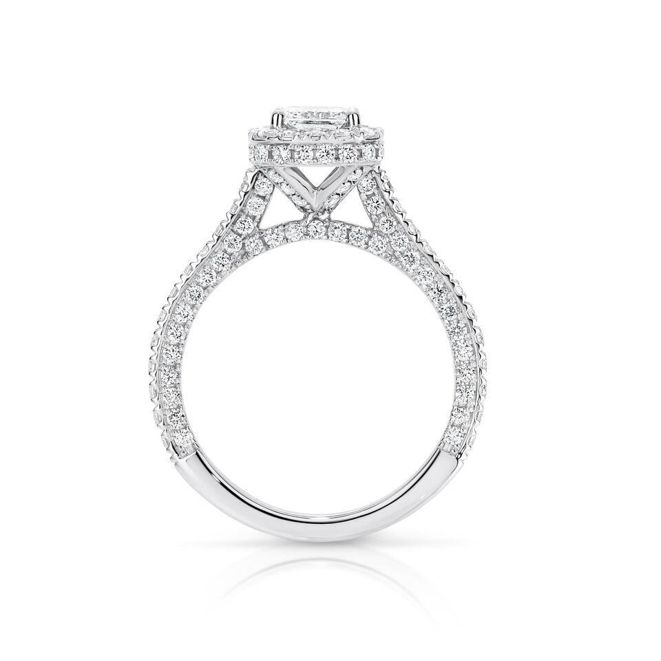 GIA certified radiant 1.00 ct F/SI2 set in 18K W/G micropave set halo ring. TCW 2.25+ cts