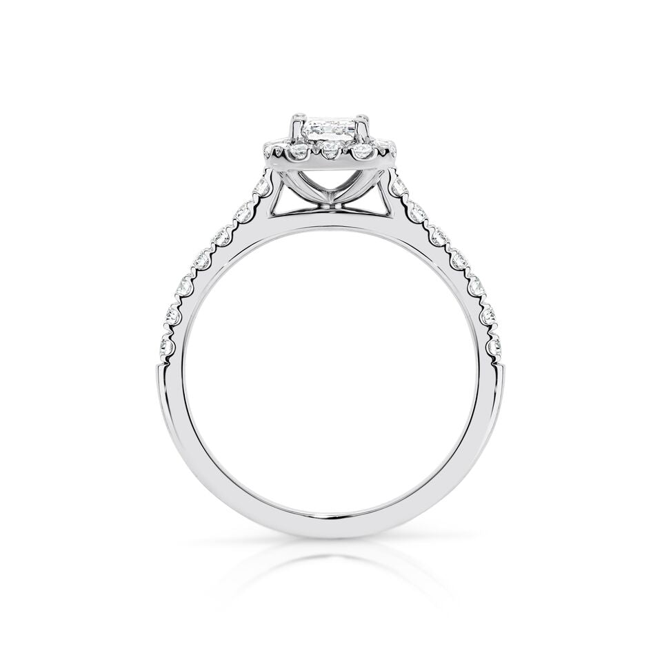 GIA certified emerald 0.70 ct F/VS2 set in 18K W/G halo ring. TCW 1.20+ cts
