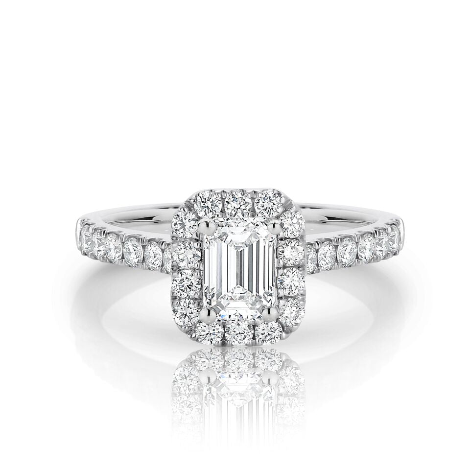GIA certified emerald 0.70 ct F/VS2 set in 18K W/G halo ring. TCW 1.20+ cts
