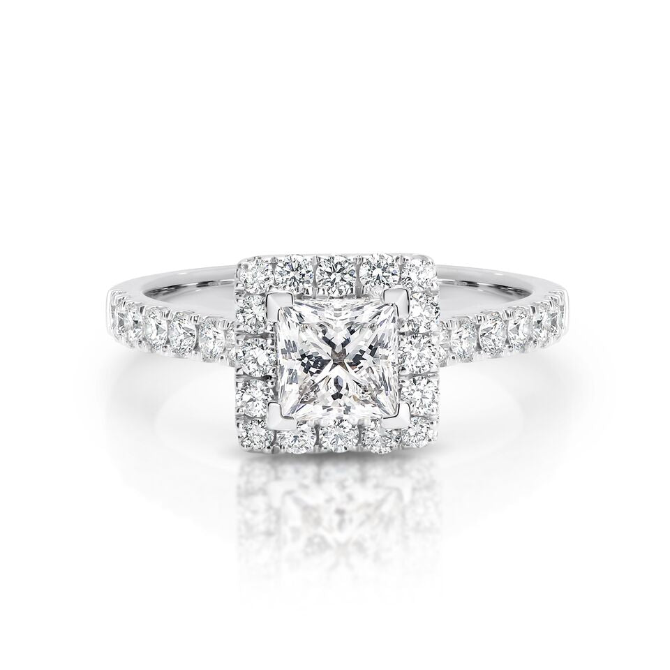 GIA certified princess 0.70 ct F/SI2 set in 18K W/G halo ring. TCW 1.20+ cts