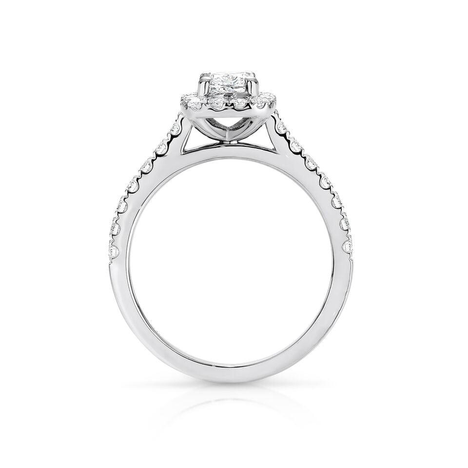 GIA certified cushion 0.70 ct F/SI2 set in 18K W/G halo ring. TCW 1.20+ cts