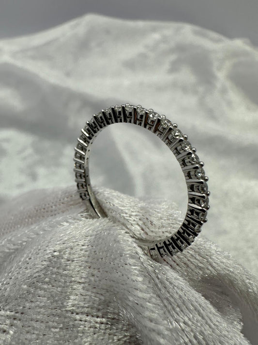 Stunning 18K white gold shared claw diamond band ring.