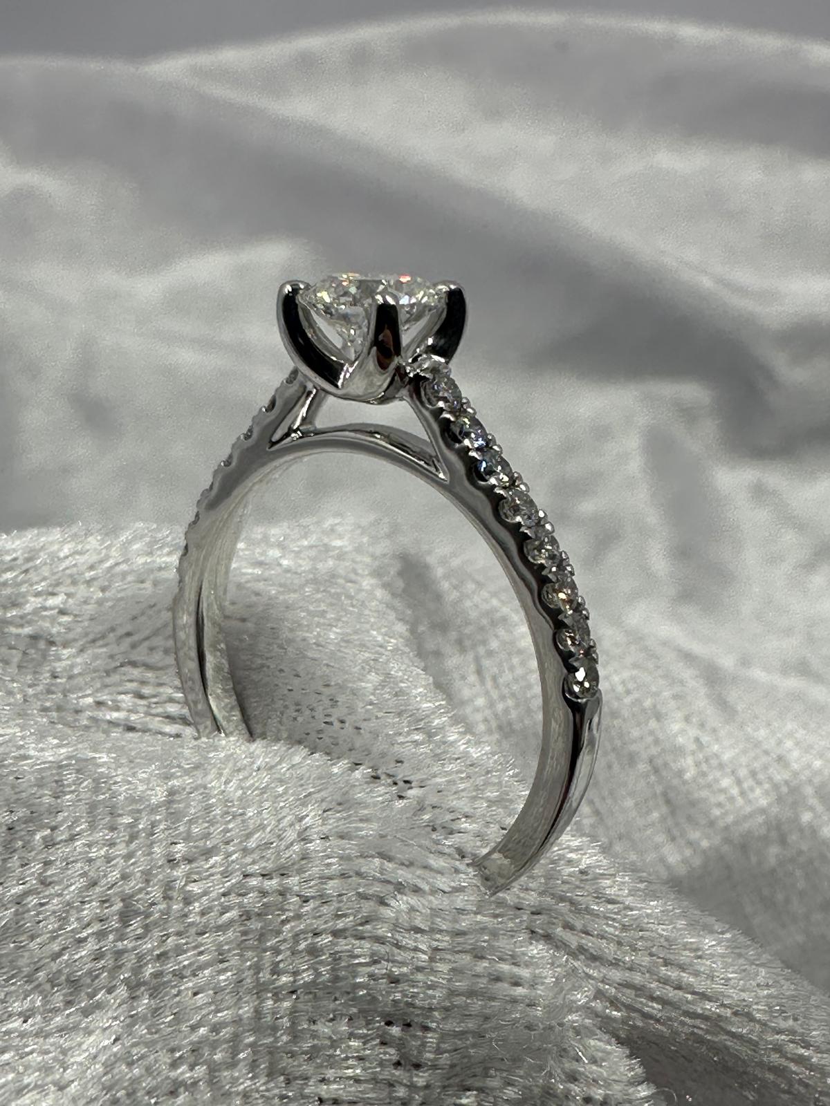 GIA certified 0.70 ct D/SI2 XXX NIL, 18K w/G pave set ring