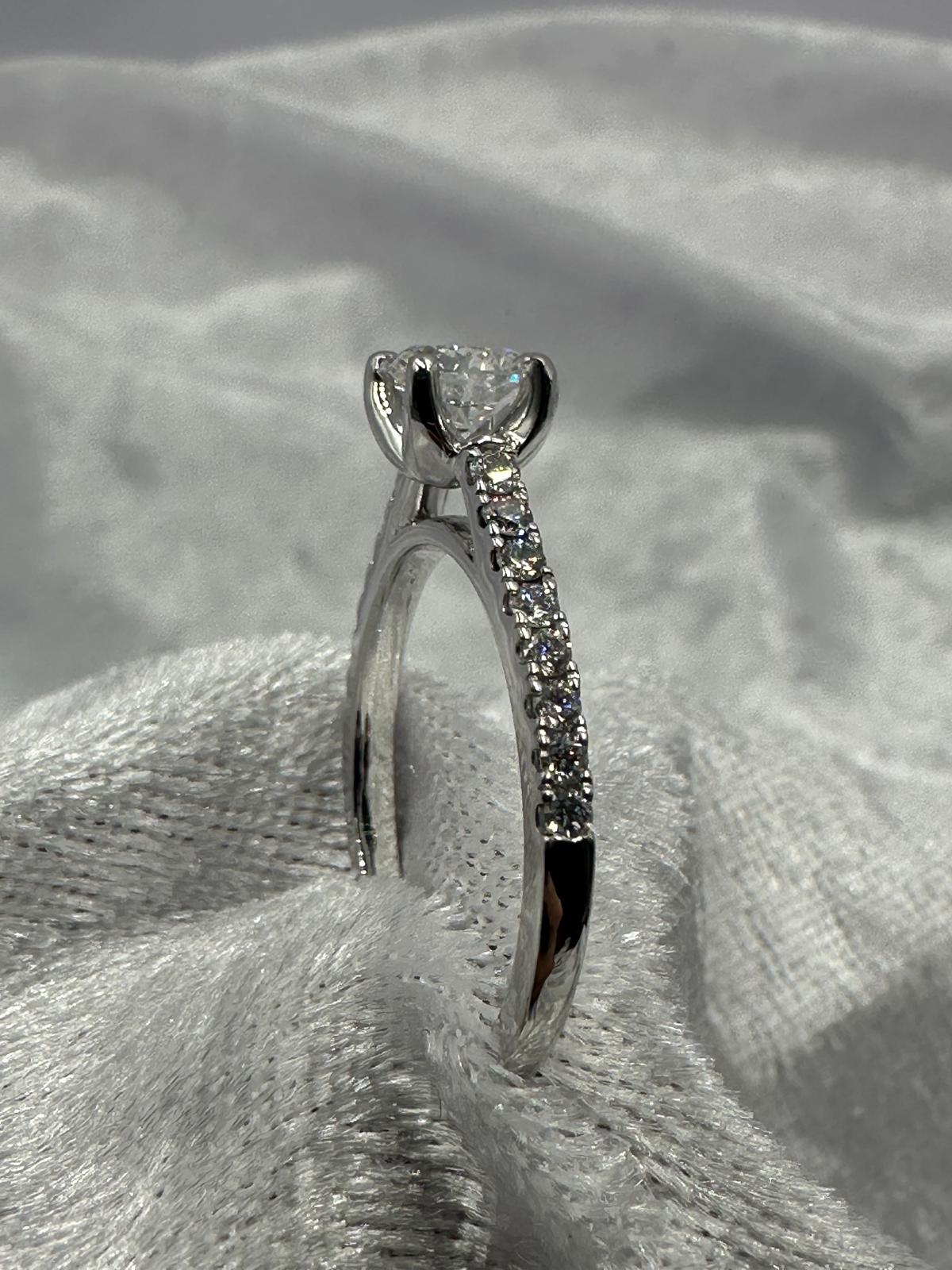 GIA certified 0.70 ct D/SI2 XXX NIL, 18K w/G pave set ring