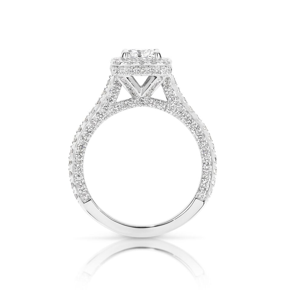 GIA certified cushion 1.00 ct F/SI2 set in 18K W/G micropave set halo ring. TCW 2.25+ cts