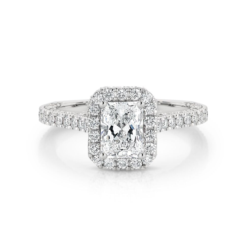 GIA certified radiant 1.00 ct F/SI2 set in 18K W/G micropave set halo ring. TCW 2.25+ cts