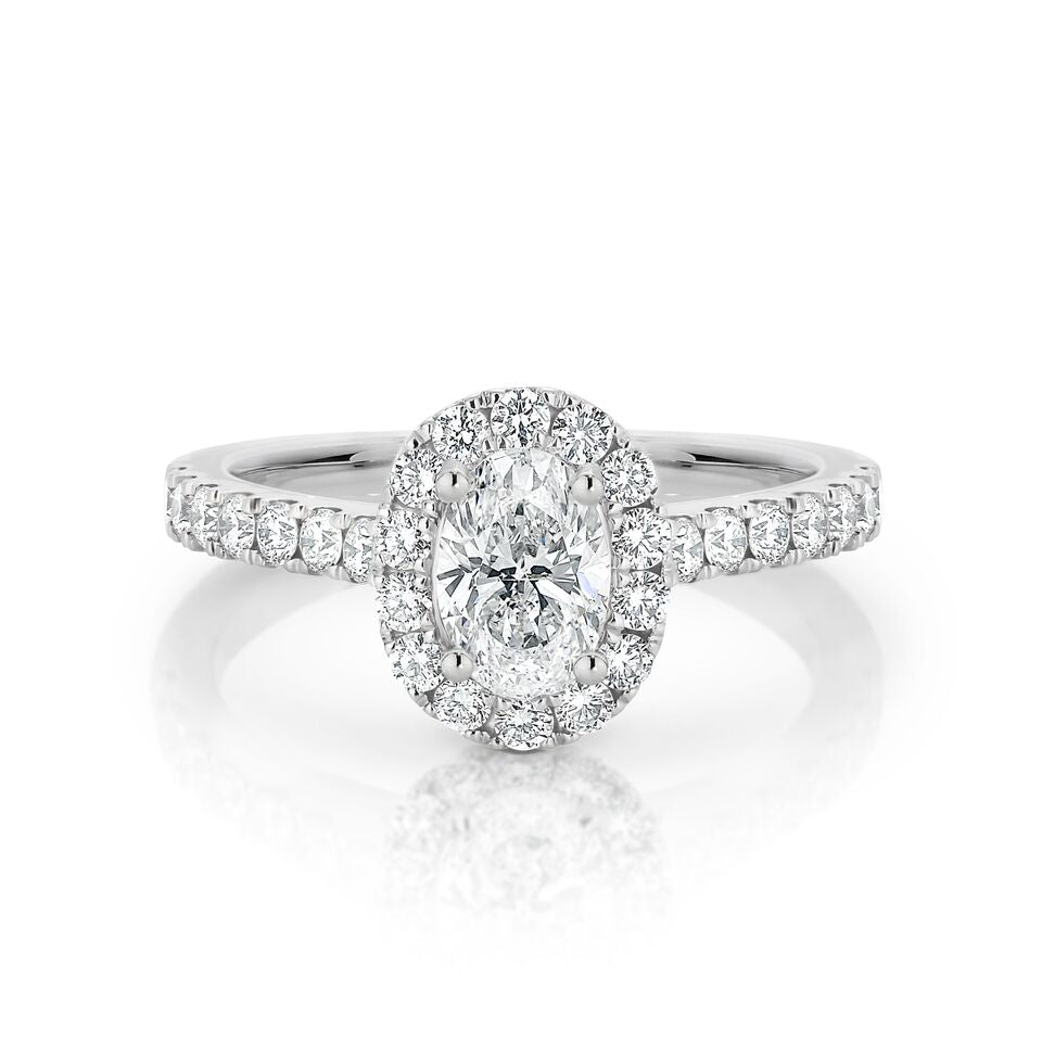 GIA certified Oval 0.70 ct F/SI2 set in 18K W/G halo ring. TCW 1.20+ cts