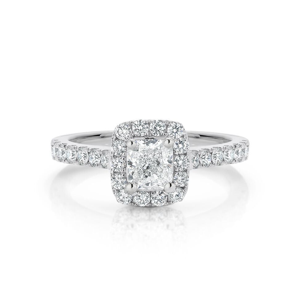 GIA certified cushion 0.70 ct F/SI2 set in 18K W/G halo ring. TCW 1.20+ cts