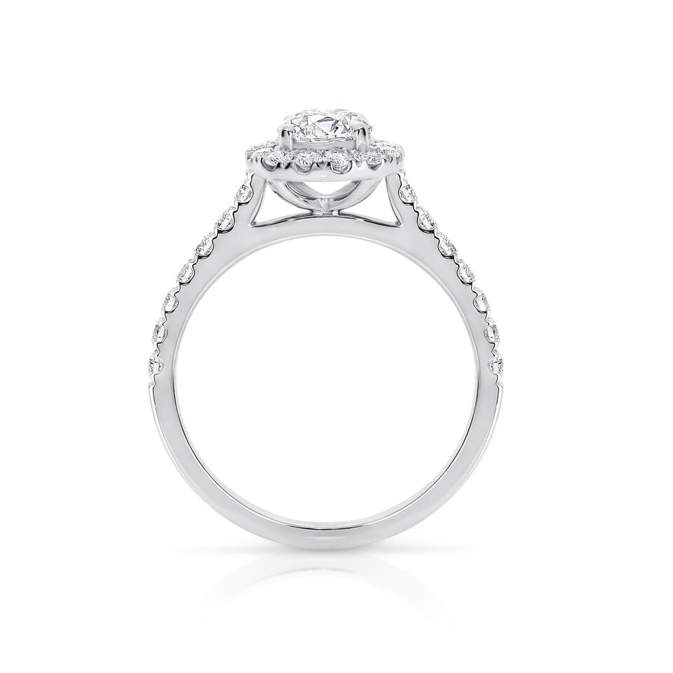 GIA certified round 0.70 ct F/SI2 set in 18K W/G halo ring. TCW 1.30+ cts