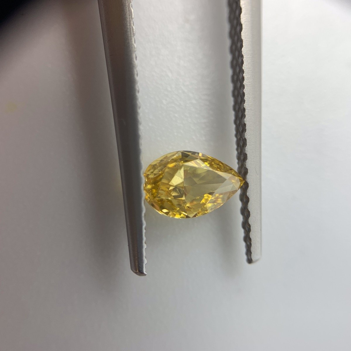 GIA Certified Pear brilliant 0.50ct Fancy Intense Orange-Yellow.