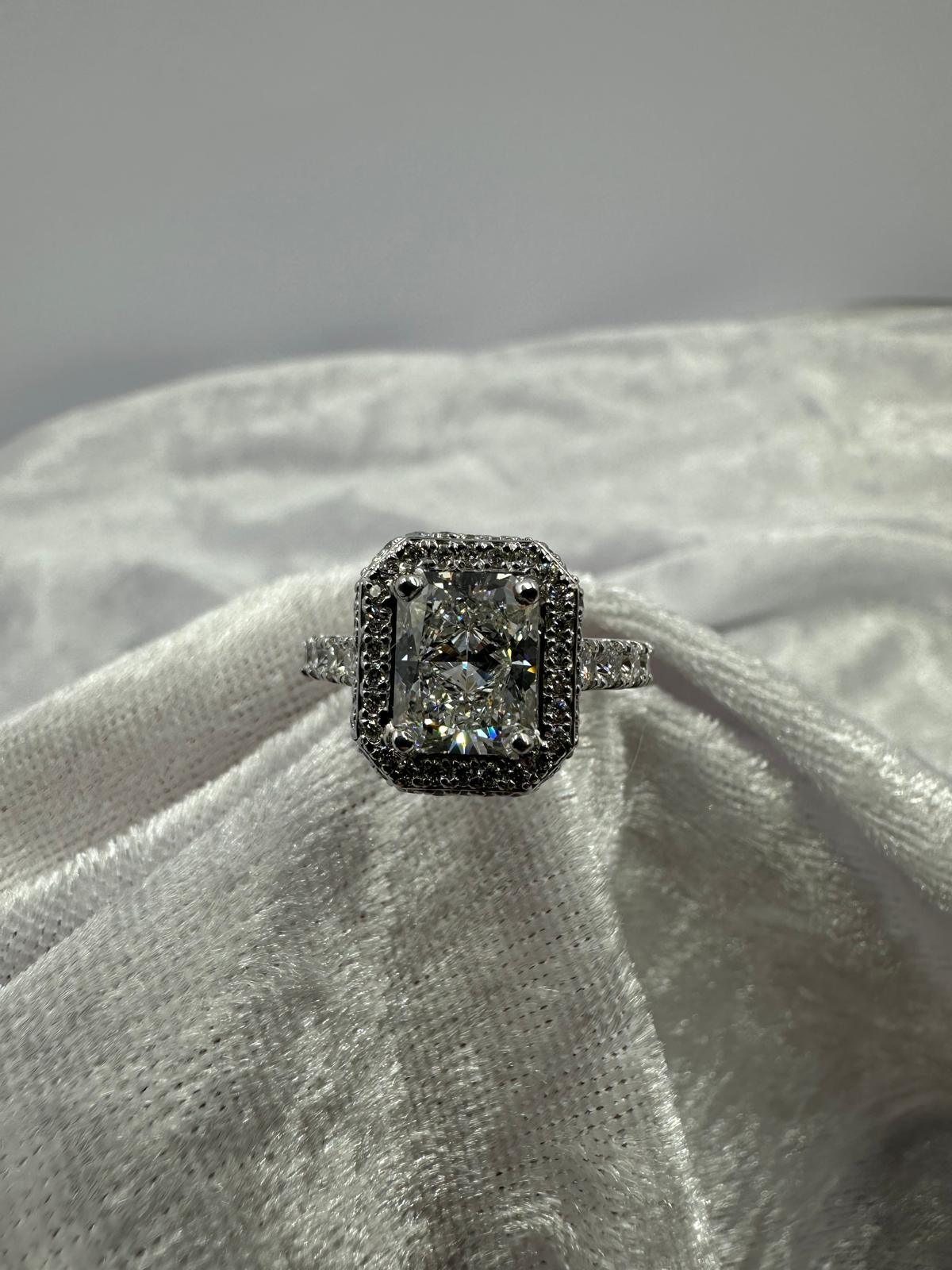 Stunning radiant cut lab grown and natural diamond halo ring. 2.99 TCW, angled view